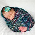 Professional baby photo in turquoise scarf