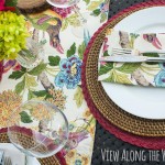 Place setting with multicolored runner and flowers on an outdoor table at View Along the Wa